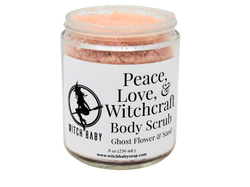 light pink scrub packaged in an 8 oz glass jar with a white label that reads: Peace, Love, & Witchcraft Body Scrub. Ghost Flower & Sand.