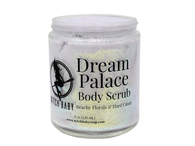8 oz glass jar filled with lavender colored body scrub and gold glitter with clear label that reads: Dream Palace Body Scrub Beachy Florals & Hard Candy