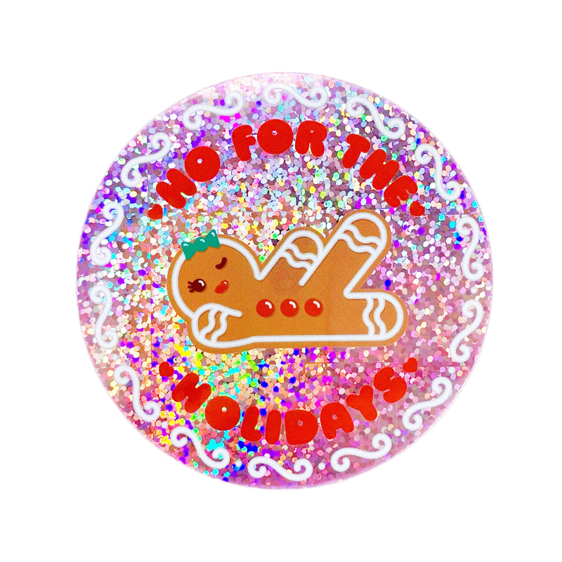 A round holographic glitter sticker with a Christmas theme, featuring a gingerbread lady, text, and colorful sparkly background.
