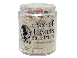 photo of 8 oz glass jar with rose petals, bits of strawberry, and bath potion powder. label reads: ace of hearts bath potion. hibiscus & raspberry. 