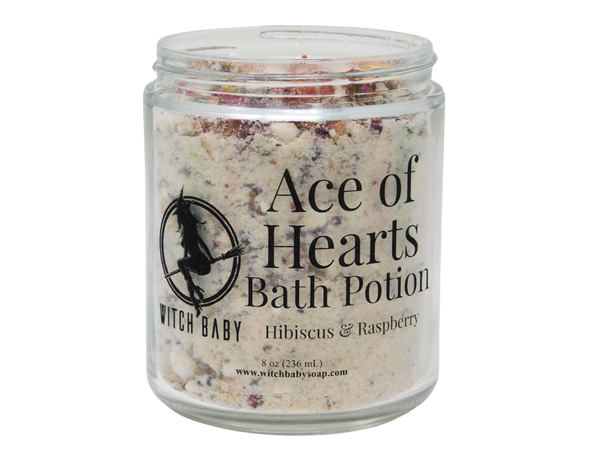 photo of 8 oz glass jar with rose petals, bits of strawberry, and bath potion powder. label reads: ace of hearts bath potion. hibiscus & raspberry. 