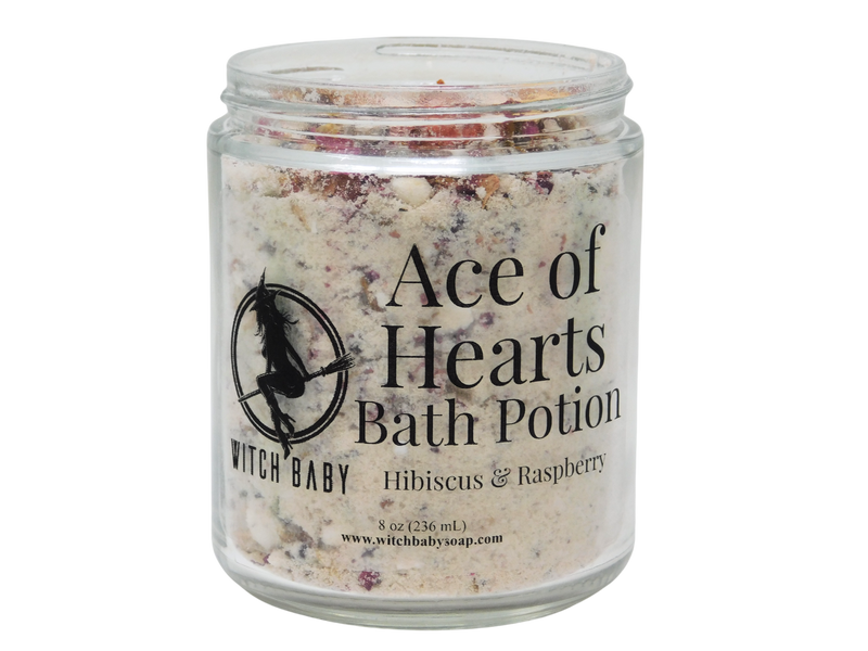 photo of 8 oz glass jar with rose petals, bits of strawberry, and bath potion powder. label reads: ace of hearts bath potion. hibiscus & raspberry. 