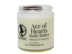 white body butter packaged in glass jar with red jasper on top and clear label that reads: Ace of Hearts body butter. Hibiscus & Raspberry. 