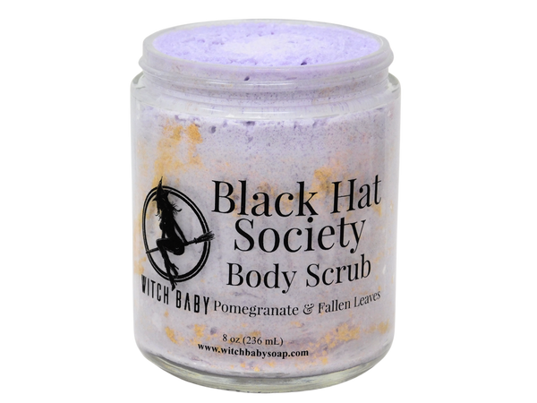 8 oz glass jar filled with thick purple body scrub and autumn leaf colored glittered. clear label reads: Black Hat Society Body Scrub. Pomegranate & Fallen Leaves. 