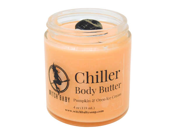 orange body butter in 4 oz glass jar topped with black onyx with clear label that reads: Chiller Body Butter. Pumpkin & Oreo Ice Cream