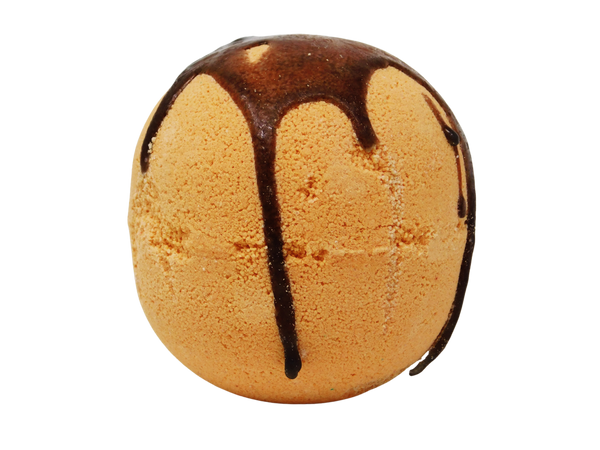 orange sphere bath bomb with dripping cinnamon colored glaze on top