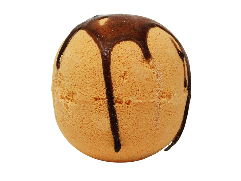 orange sphere bath bomb with dripping cinnamon colored glaze on top