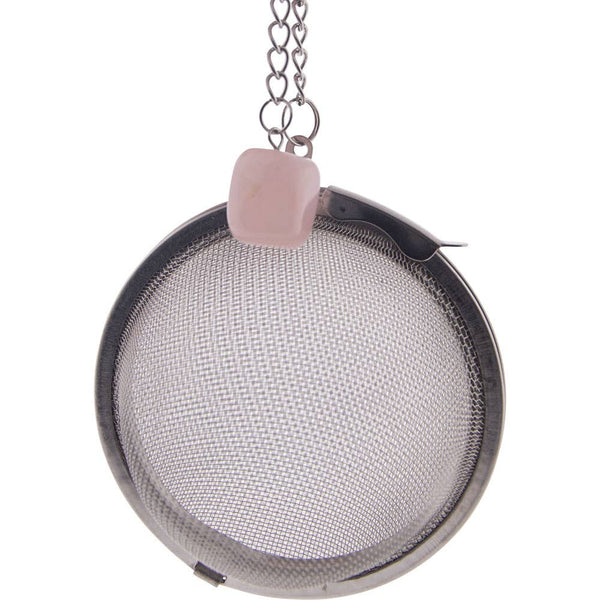 A stainless steel tea infuser ball with a rose quartz crystal attached to a chain, featuring a fine mesh interior.