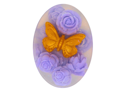 clear oval soap with gold butterfly and purple roses.