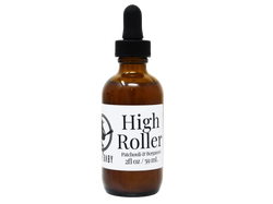 photo of product with white label that reads high roller body oil. Patchouli & Bergamot. 