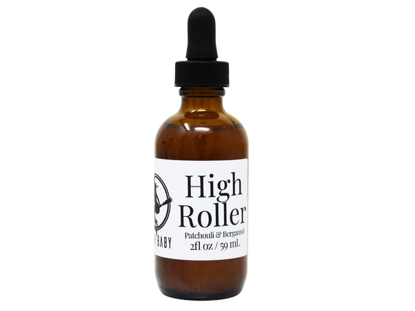 photo of product with white label that reads high roller body oil. Patchouli & Bergamot. 