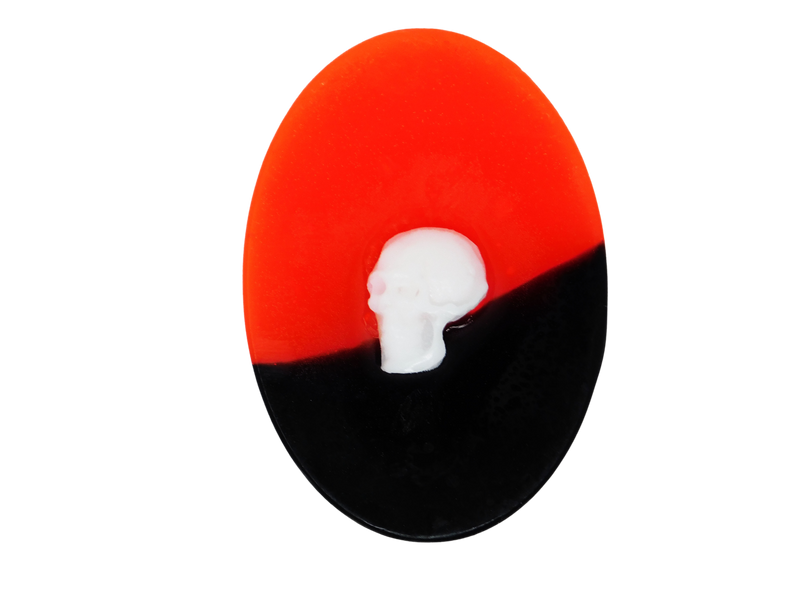 oval neon red and black soap with white skull on top