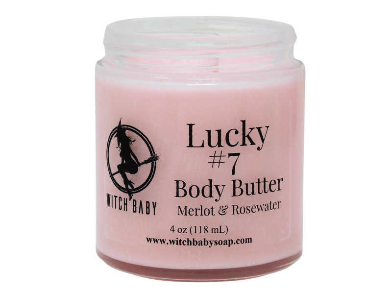 front view of pink lucky #7 body butter with a clear label that reads: Lucky #7 body butter. Merlot & rosewater. 