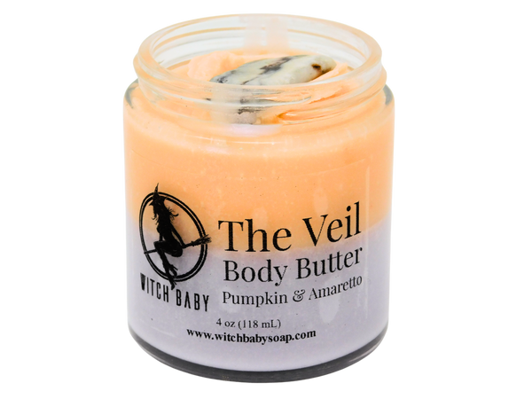 orange and purple body butter topped with crazy lace agate in a 4 oz glass jar with a clear label that reads: The Veil Body Butter. Pumpkin & Amaretto.