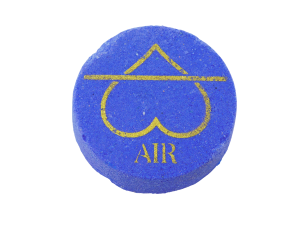 dark periwinkle circle bath bomb with air symbol in gold on it in the shape of a heart instead of a triangle and it says AIR beneath it