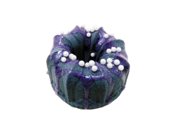 dark indigo bundt cake shaped bath bomb drizzled with purple soap with pearlescent sprinkles on top