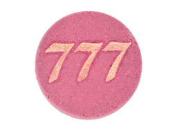 pink circular bath bomb with 777 in gold mica on front