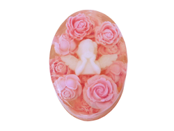 oval soap with white baby cherub in the center surrounded by pink roses