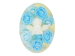 Oval clear soap with a white angel at the center surrounded by sky blue roses