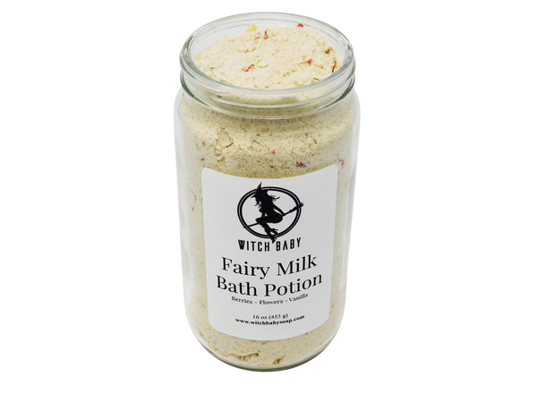 white powdery bath potion full of flowers and salt in a 16 oz glass jar with a label that reads: Fairy Milk Bath Potion. Berries - Flowers - Vanilla..