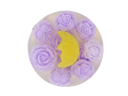 circular clear soap packed with violet colored roses and a golden crescent moon