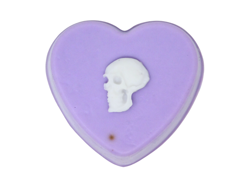 Pastel purple heart shaped soap with white skull on top.